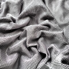 Synthetic fabric with holes laid in waves. Beautiful drape. Fabric for curtains, interior design,...
