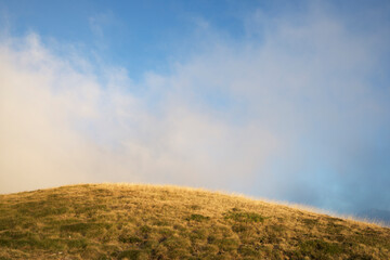 Idyllic view of mountain against cloudy sky