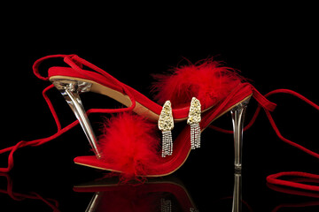 sexy, red strappy high heel shoes with box on a black background