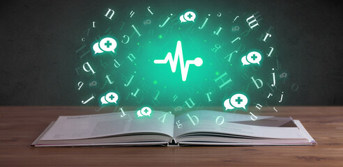 Open medical book with health icons above