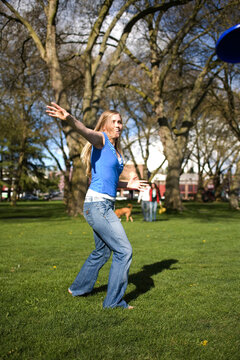 SEATTLE, WASHINGTON. A young woman throwing a frisbee in the park.