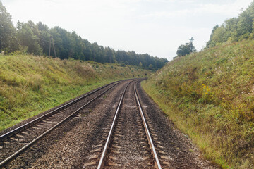 Fototapeta na wymiar railway in natural environment, view from the driver's cab