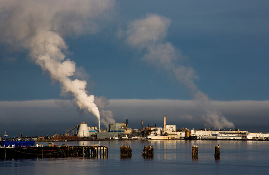 Mill emitting smoke on waterfront of Port Angeles, Washington State, USA