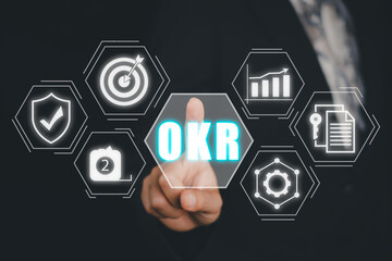 OKR, Objectives and Key Results concept, Business person hand touching Objectives and Key Results...