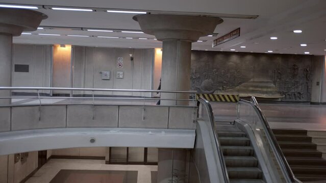 Slow-motion shot of a businesswoman walking down the stairs at metro station