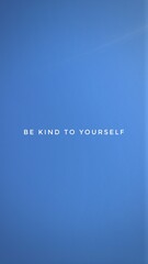 A motivational quote, “BE KIND TO YOURSELF” isolated on beautiful blue sky background