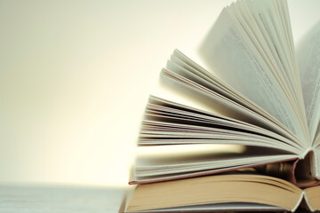 stack of books on a wooden table on a light white blurred background. soft focus.Learning and knowledge symbol. High quality photo
