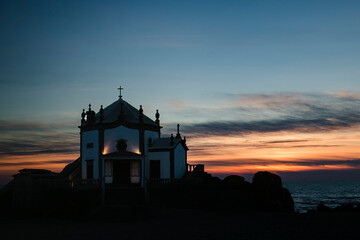 Chapel Senhor da Pedra at night in Miramar Beach, Portugal.