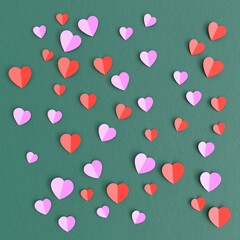 folded paper hearts scattered on dark green fabric background