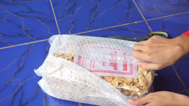Video of someone opening a packet of light snacks
