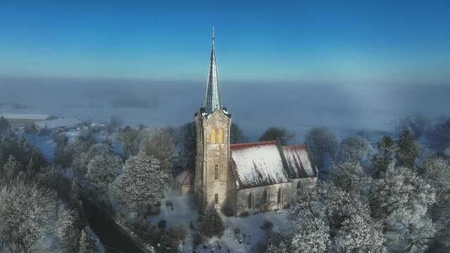 Part of rare weather phenomenon white rainbow behind the Church of Blessed Virgin Mary in J&otilde;el&auml;htme. Estonia.