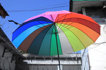 The colorfull umbrella under cloud dark blue sky.