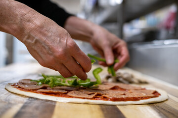 Chef making a pizza in restaurant kitchen