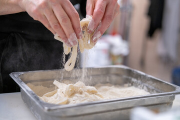 Female chef preparing fried calamari