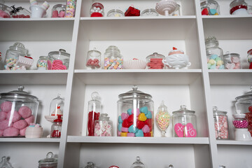 Display shelves stocked with jars of Valentine candy and hearts