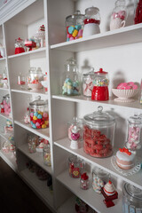 Display shelves stocked with jars of Valentine candy and hearts