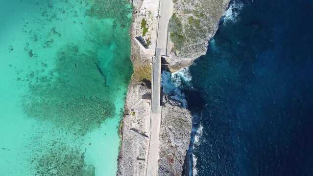 Cinematic aerial view still top down drone shot of an empty glass window bridge on the island of eleuthera in the bahamas - separating the atlantic ocean from the caribbean sea