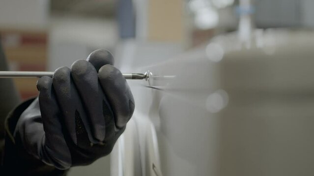 Electric Technician Wearing Gloves Unscres Air Conditioner Box Screw