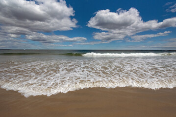 Fototapeta na wymiar Sand, surf, and sky