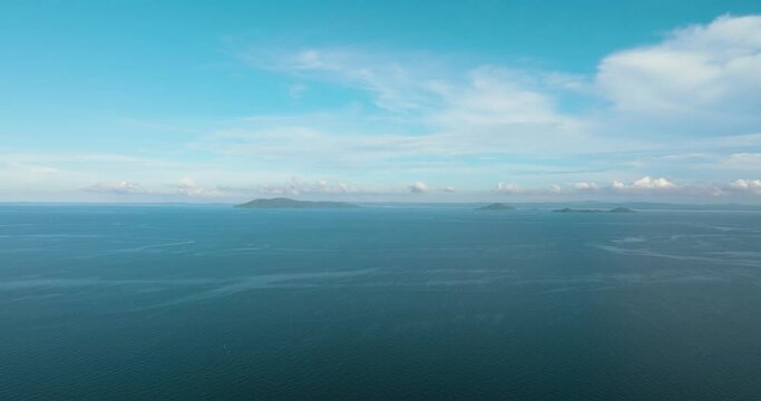 Tropical islands in the blue sea against the background of the sky and clouds. Philippines.