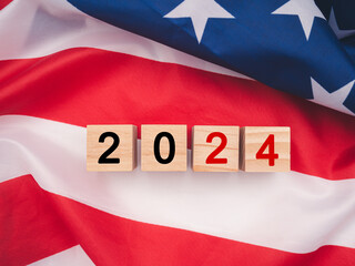 Wooden cubes with letters VOTE over the American flag background