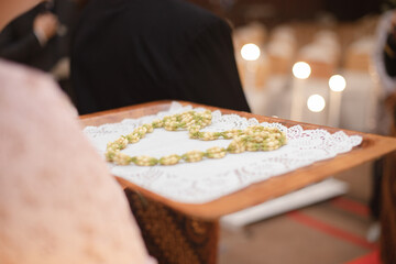 Arrangements of jasmine that have not yet bloomed are made into necklaces that serve as a receipt for the arrival of the groom