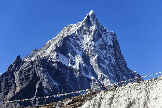 View of Mt. Tobuche with Tibetan prayer flags near Dingboche, Sagarmatha National Park, Solukhumbu, Nepal.