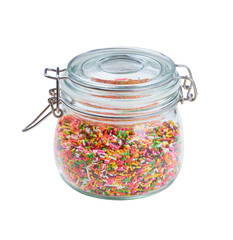 A clear glass jar with a lockable lid (KORKEN) isolated on white background. Containing colorful Icing sugar used for topping such as Decorate cakes, ice creams, donuts and cupcakes.