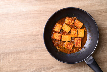 Korean side dish, spicy braised tofu (Dubu Jorim) in cooking pan, Table top view