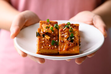 Korean side dish, spicy braised tofu (Dubu Jorim) with hand