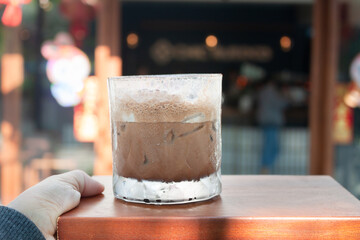 Iced coffee with micro foam in coffee shop