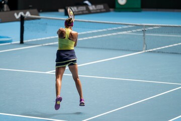 Plakat female Professional athlete Tennis player playing on a court in a tennis tournament in summer
