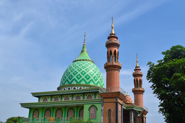Green Mosque, Indonesia. in the morning with blue sky and white clouds