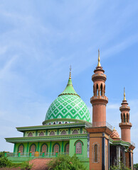Green Mosque, Indonesia. in the morning with blue sky and white clouds