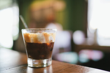Fresh brew Vietnamese Coffee in glass with blur background