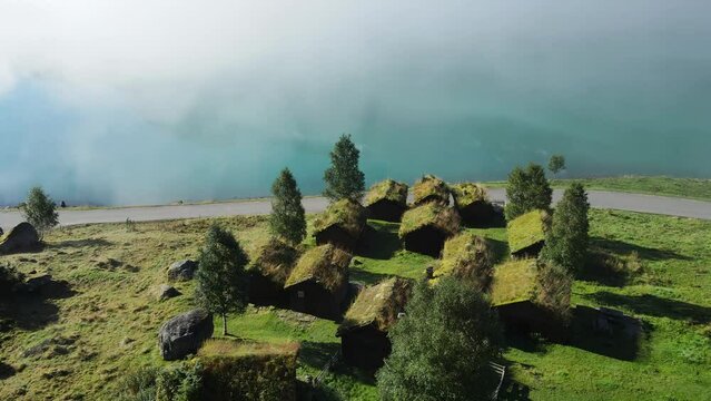 Lovatnet glacier lake and Breng seter historical farm houses in mist. Drone footage. Norway