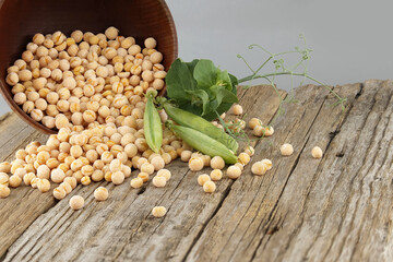 Peas spilling from a rustic bowl on wood table