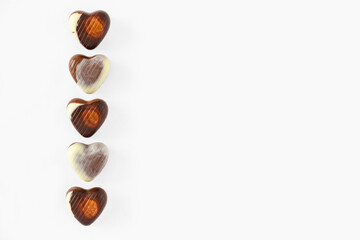 Row of Belgium chocolate hearts on a clean white background, Happy Valentine's Day
