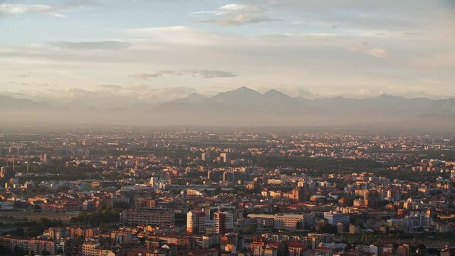 Foggy Grigne mountains and Milan cityscape, view from above