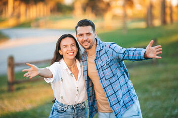 Portrait of happy couple in the park on summer day outdoors