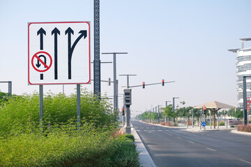 Large board of a series of road signs on an empty highway, no U-turn, highway exit