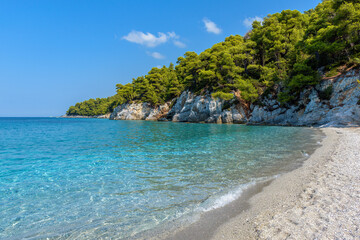 Fototapeta na wymiar The famous pebble beach kastani with the turquoise waters where the famous Mamma Mia movie was filmed, located in Skopelos island, Sporades, Greece.