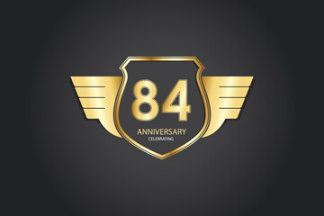 84 years anniversary logotype 3D golden stylized modern shape winged shield on black background