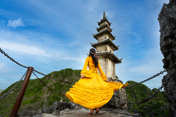 Asian woman on Hang Mua viewpoint at Tam Coc, Ninh Binh. Vietnam and blue sky