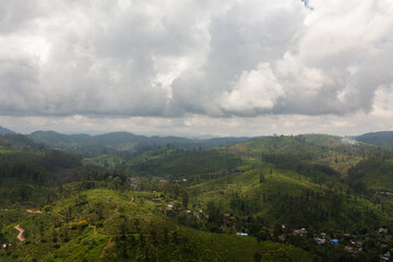 Obraz premium Aerial view of Farmers' houses among tea estates in the mountains. Maskeliya. Tea plantations in Sri Lanka.
