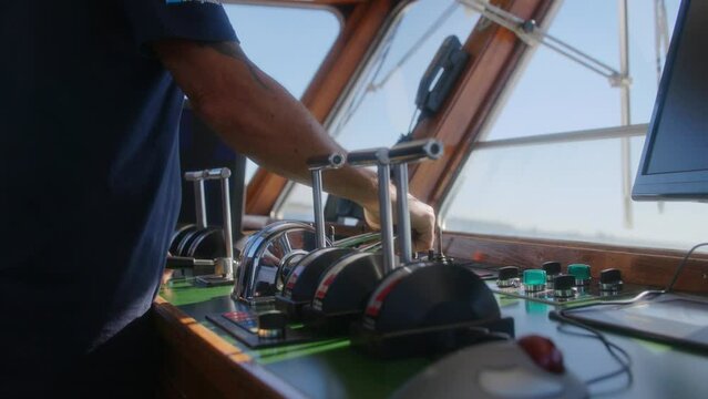 Captain of a boat operating the ship on a sunnyday in slowmotion