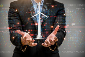 Businessman hand holding glowing digital wind mill turbine hologram, Wind generator and clean energy concept.