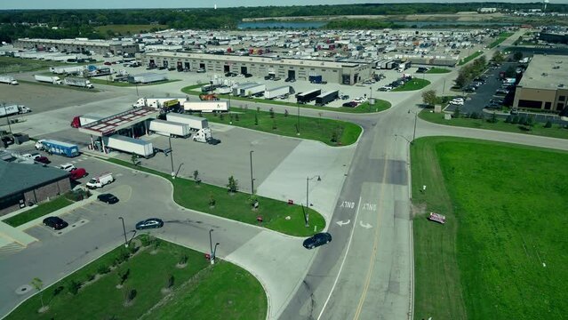 aerial in East Dundees Illinois. plaza of truck repair shops and parking lots full of reefers, dry vans, flatbets step decks. Trucking industry aerial.