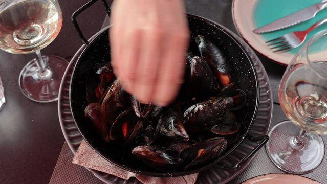 Picture of steamed tasty mussels served on pan with lemon, tapas of spanish cuisine