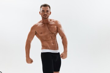 Obraz premium Man athletic body bodybuilder in briefs with naked torso abs full-length in the background, fitness classes. Advertising, sports, active lifestyle, competition, challenge concept.